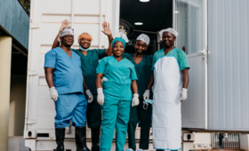 Surgical staff outside a mobile clinic, following successful surgery, in Montepuez district, Mozambique. With many health facili